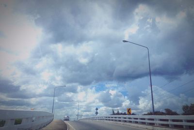 Low angle view of road against cloudy sky