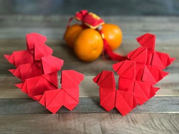 Close-up of red and paper on table