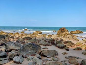 Rocks on beach against sky