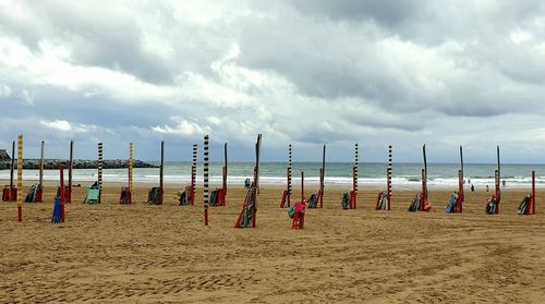 Group of people on beach against sky