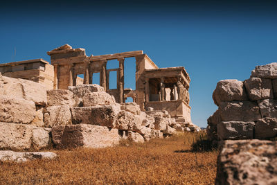 Low angle view of ancient built structure against clear blue sky