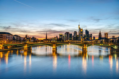 Bridge over river with buildings in background