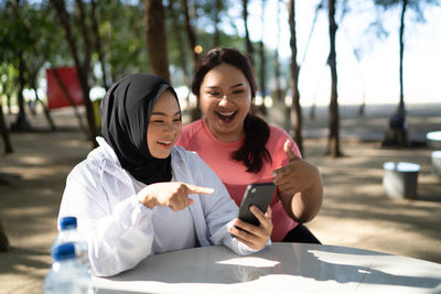 Portrait of young woman using mobile phone