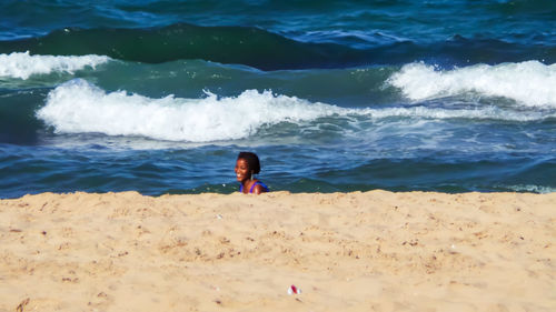 Full length of woman on beach against sky