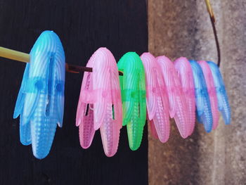 Multi colored clothespins hanging on clothesline
