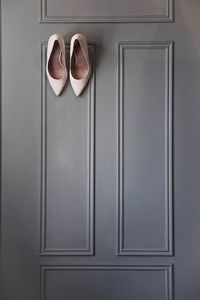 Close-up of shoes on door