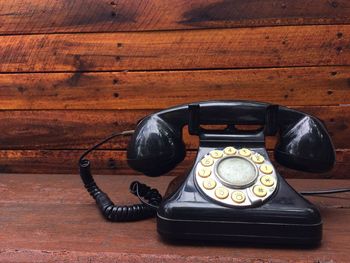 Close-up of old telephone on table