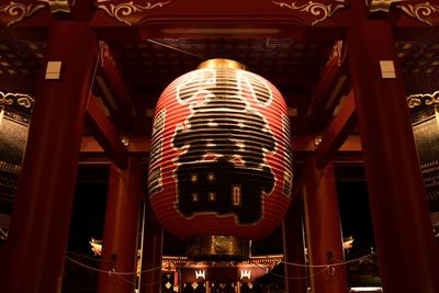 Low angle view of illuminated lanterns hanging in building