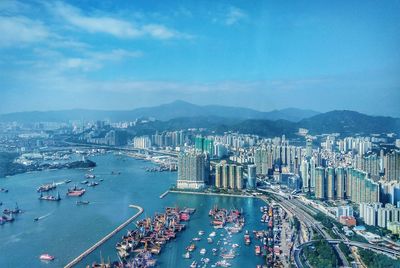 High angle view of city by sea against sky