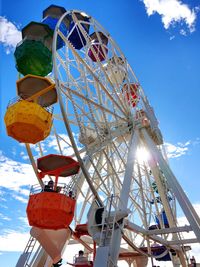 Low angle view of ferris wheel against sky