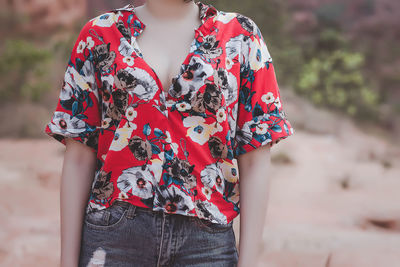 Midsection of woman wearing floral pattern shirt