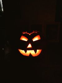 Close-up of illuminated pumpkin against black background