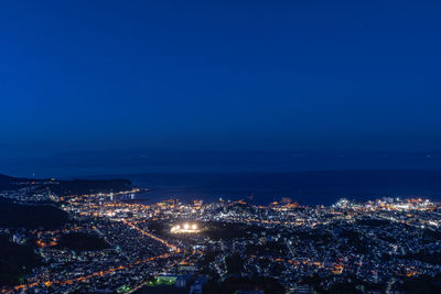 High angle view of illuminated city buildings at night