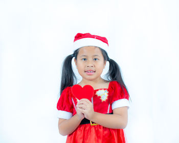 Portrait of cute girl against white background