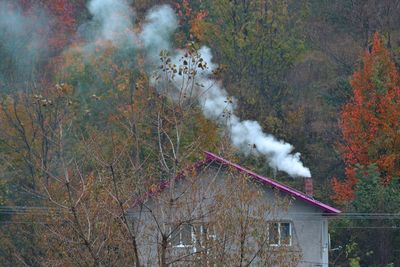 Smoke emitting from house chimney