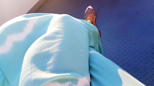 Low section of woman relaxing in swimming pool