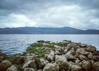 Scenic view of sea against cloudy sky