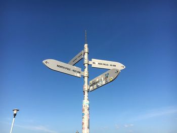 Low angle view of road signs against sky