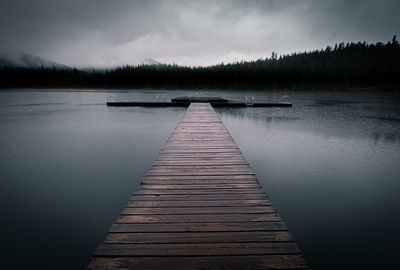 Pier over lake against sky
