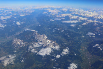 Aerial view of snowcapped mountains against sky