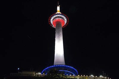 Low angle view of illuminated tower against sky at night