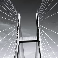 Low angle view of suspension bridge against sky