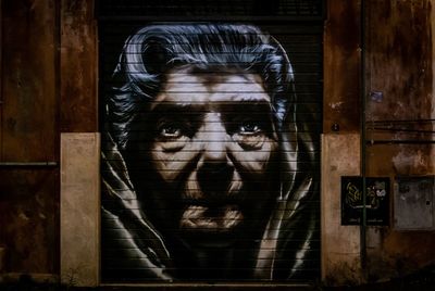 Mural of old woman on building