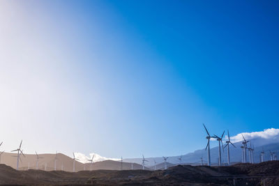 Scenic view of windmills on field 