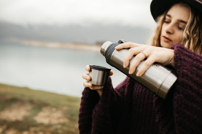 Close-up of woman drinking coffee in winter