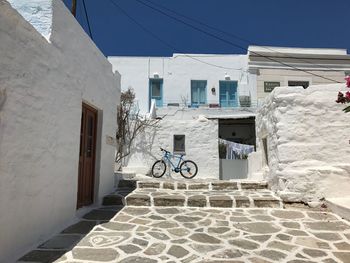 Footpath by building against sky