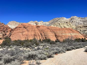 Rock formations in desert against clear blue sky