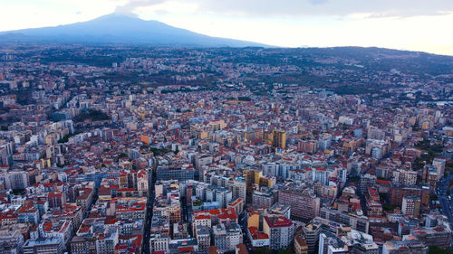 The city of catania and mount etna from a bird's eye view. sicily, italy