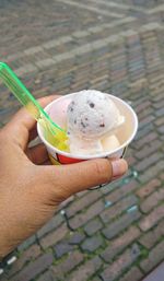 Close-up of hand holding ice cream