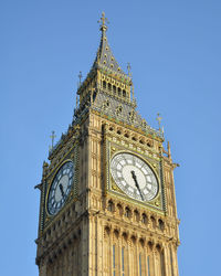 Low angle view of clock tower against clear sky