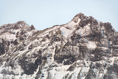 Low angle view of snowcapped mountain against sky