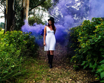 Whimsical lady playing with purple dust