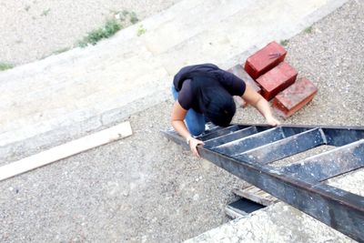 High angle view of woman on ladder