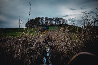 Man working on field against sky