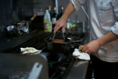 Midsection of chef preparing food in kitchen 
