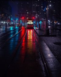 Railroad car on tramway in city at night