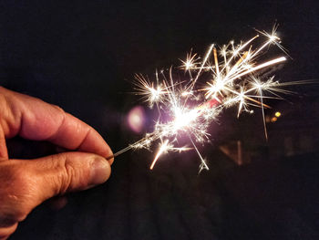 Low angle view of firework display at night