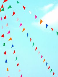 Low angle view of colorful bunting flags against sky