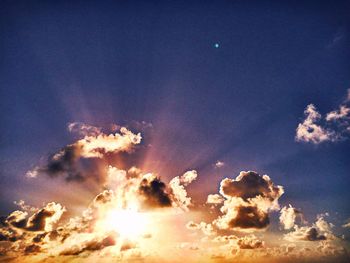 Low angle view of clouds in sky at sunset