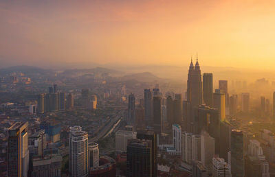 Aerial view of city buildings during sunset