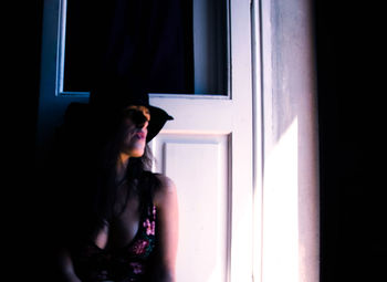 Young woman looking away at home