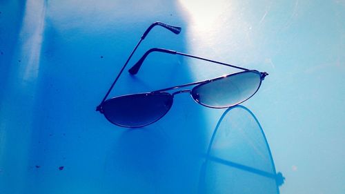 Close-up of sunglasses on swimming pool