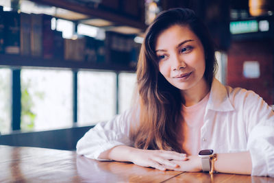 Portrait of young woman using phone