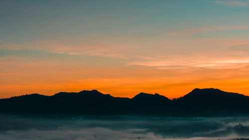 Sunrise with lembang landscape panorama, bandung, indonesia. golden sunrise with mountain scenery