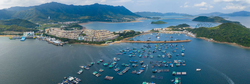 High angle view of sea and city against sky