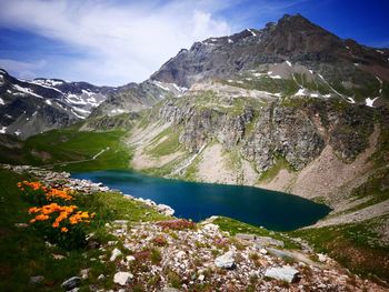 Scenic view of lake and mountains against sky